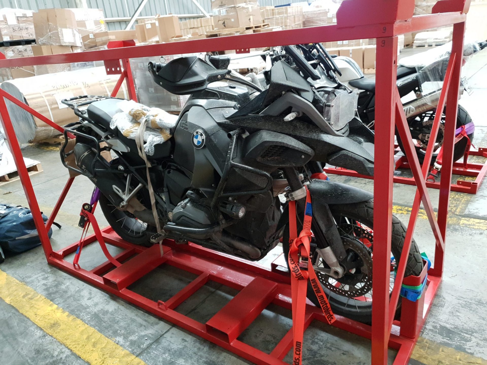 Motorcycles safely secured in transport cages