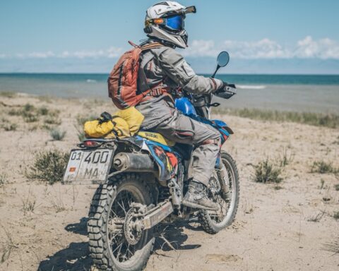 Motorcycle beside a mountain lake in Kyrgyzstan