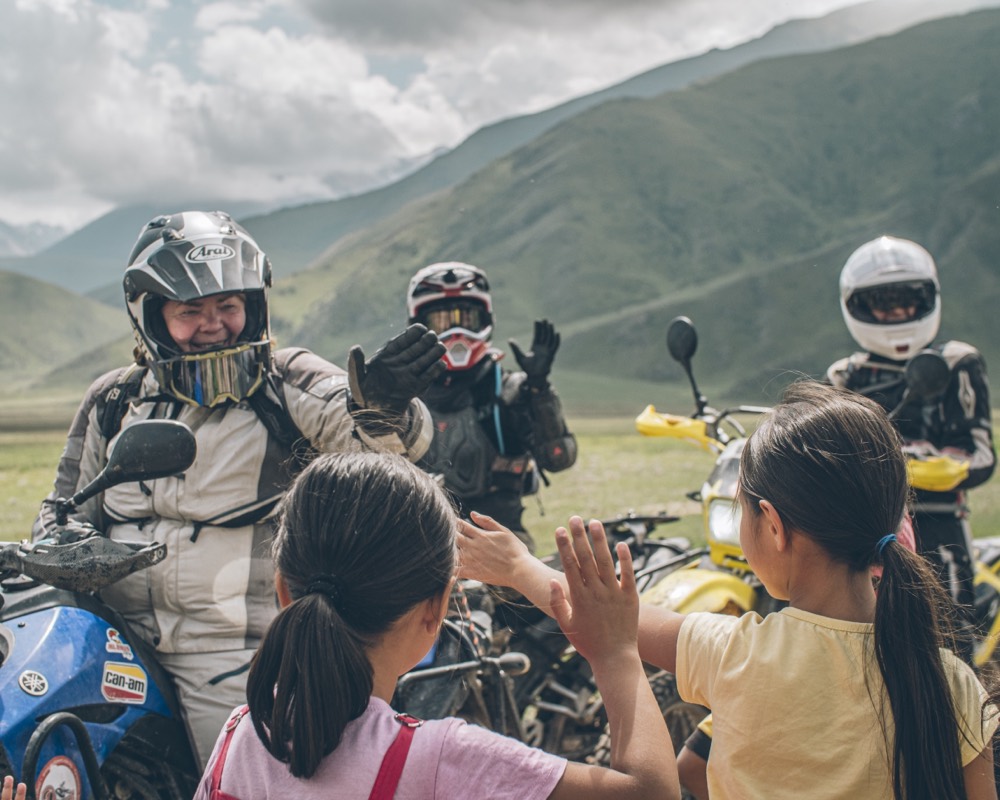 MotoBirds riders meeting a local community in Kyrgyzstan