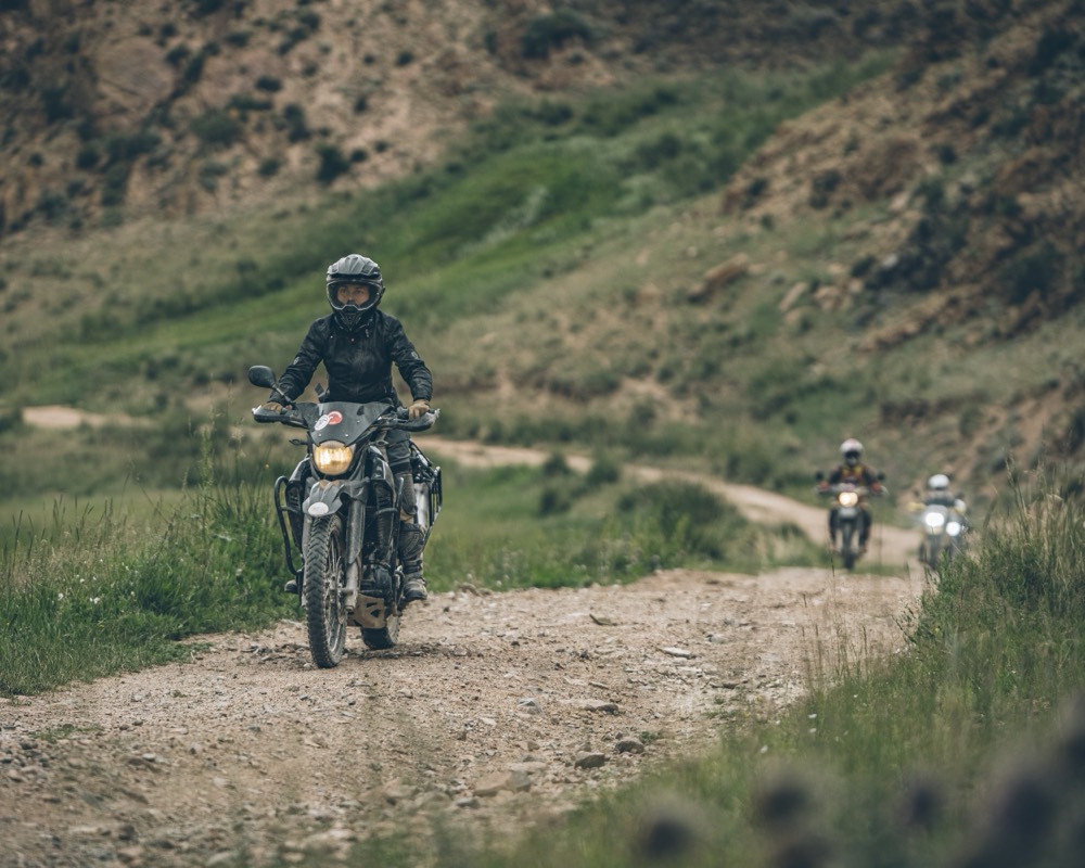 Motorcyclists riding a mountain trail in Kyrgyzstan
